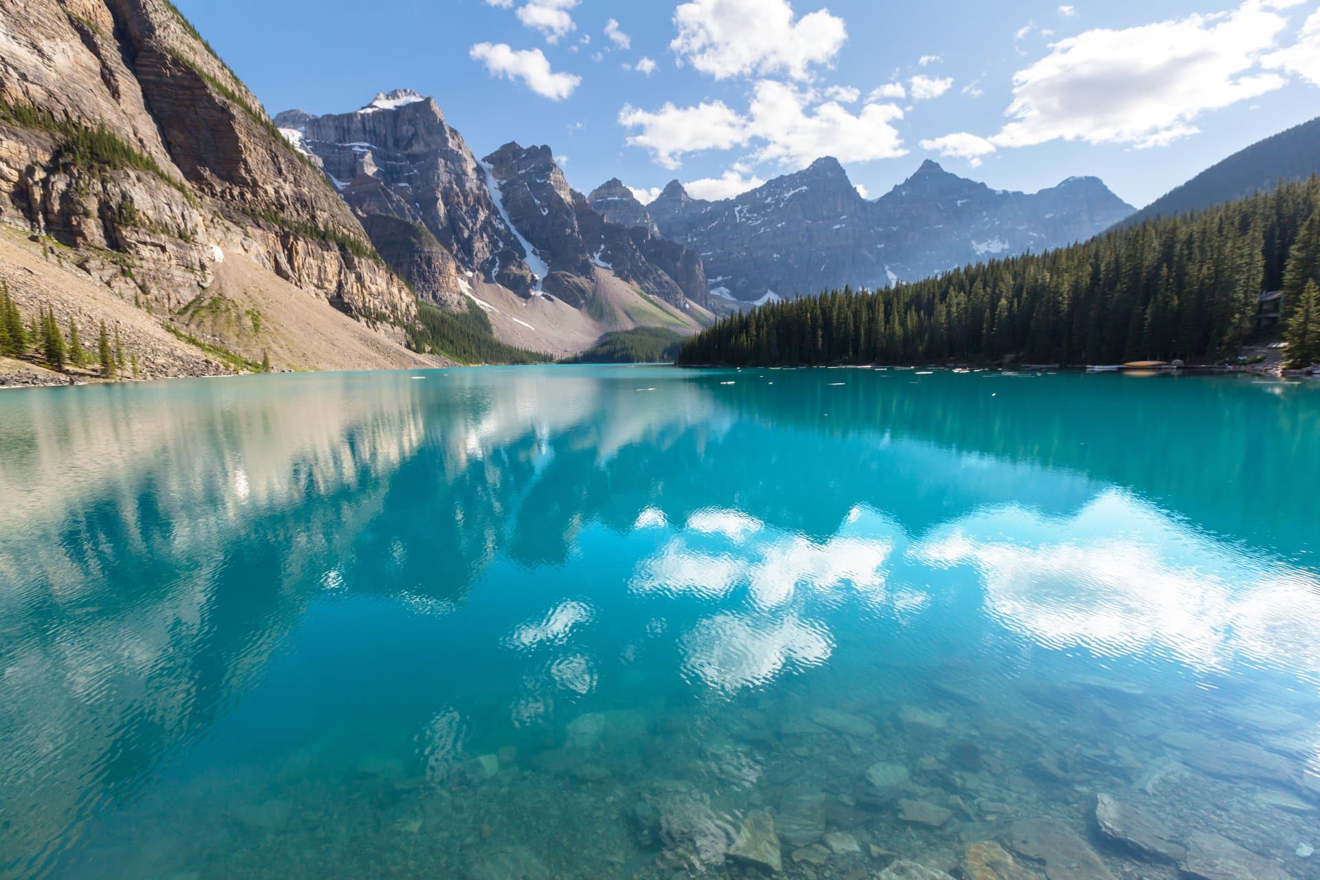 Pristine mountain lake reflecting snow-capped peaks